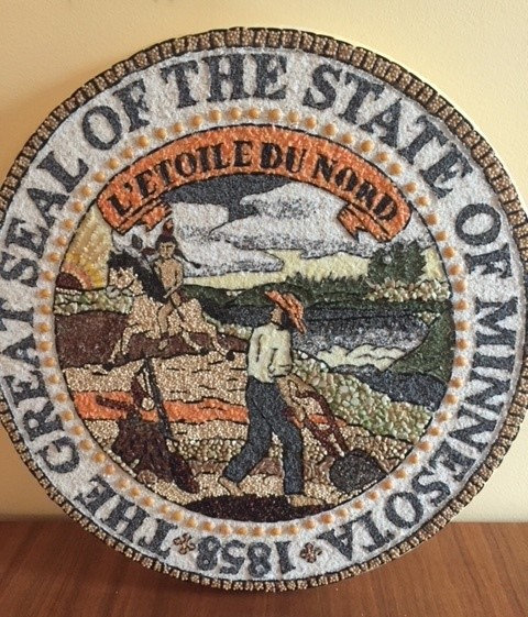 [Charlotte Ferlic State Seal image]